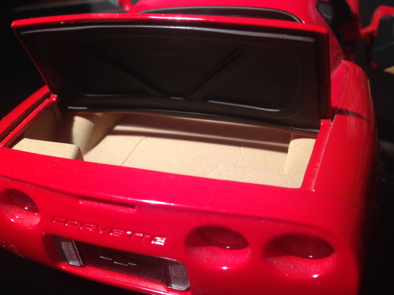 Trunk is flocked, with a trim piece attached to the under-side of trunk lid. Odd coloring of plastic rear bumper evident in this picture.